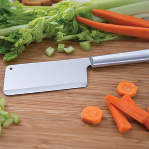 Silver handle Rada Cutlery Chef's Dicer on a cutting board with various vegetables.