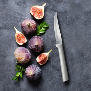 Figs and a knife on a dark surface