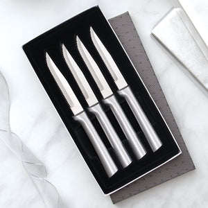 Four Serrated Steak Knives Gift Set with silver handles in a black-lined gift box