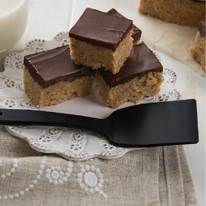 Small black nylon spatula with Scotcheroos on plate.