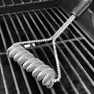 Grill Brush for cleaning grill grate, laying on top of the grill.