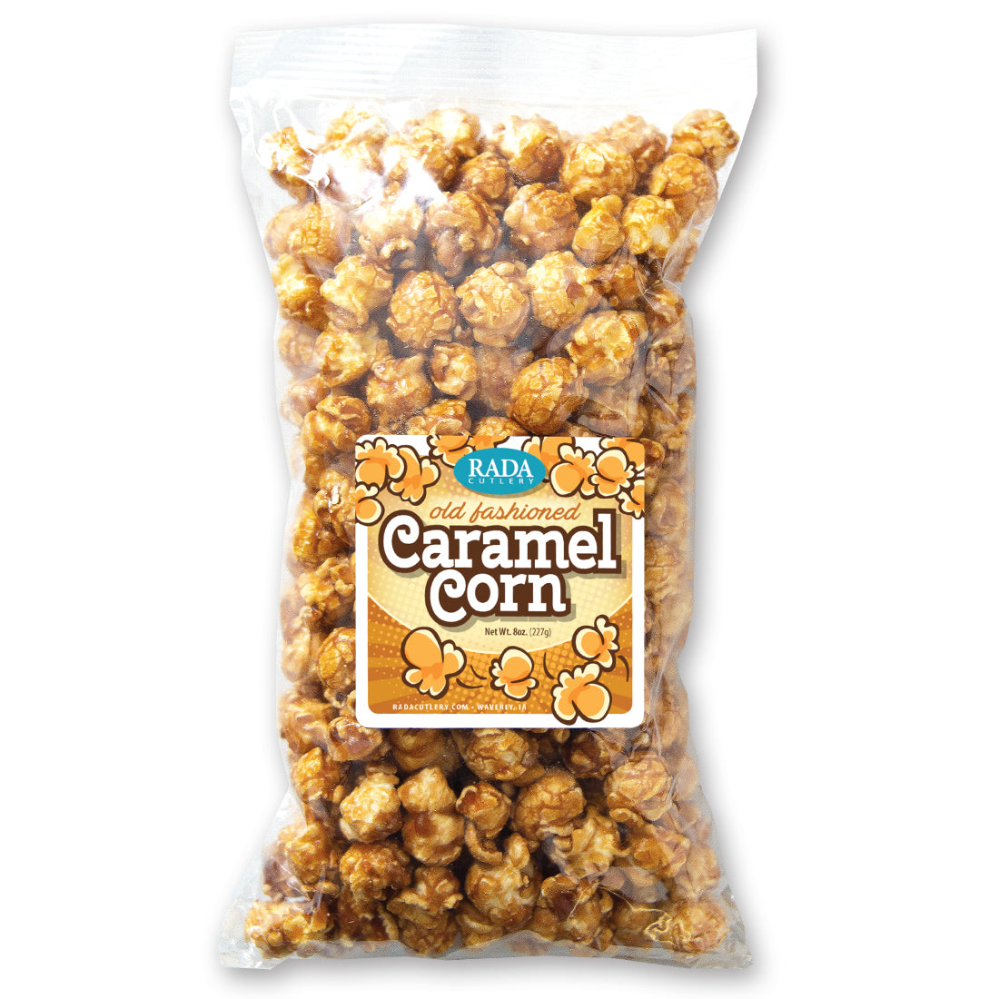 Caramel popcorn in a bowl spread out with a popcorn scooper.