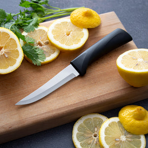 Rada's Anthem Super Parer Knife with lemons and greenery around it.