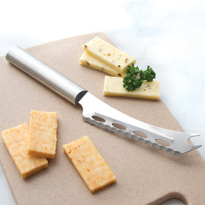 Rada Cutlery Cheese knife on a cutting board with slices of Monterey Jack and Buffalo Cheddar cheese with a garnish of parsley.