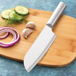 Cook's knife with silver aluminum handle and sharp blade on wooden cutting board
