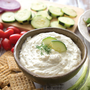 Cucumber Onion Dill Dip mixed with sour cream and served with crackers and veggies.