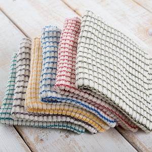 Pile of six woven multi-colored dishcloths.
