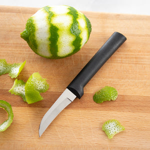 Black Granny Paring with a peeled lime on a cutting board and lime peels surround it.