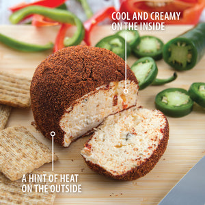 A Rada Sweet Hot Pepper Cheeseball on a cutting board. Cool and creamy on the inside. A hint of heat on the outside.