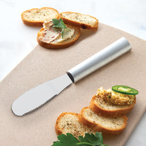 Rada Cutlery Party Spreader with silver handle beside party food.