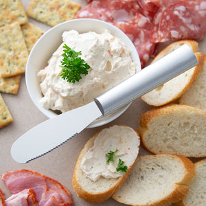 Party Spreader with silver handle and party foods. 
