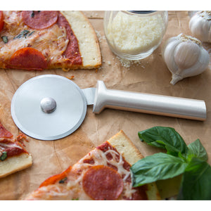 Pizza cutter with silver handle by pepperoni pizza, Parm, garlic & basil
