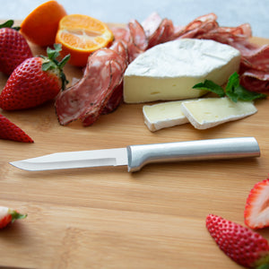 Serrated Regular Paring knife with silver aluminum handle on cutting board with fruits & cheese. 
