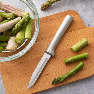 Rada silver handle Serrated Regular Paring laying down, aimed down next to whole and chopped asparagus.