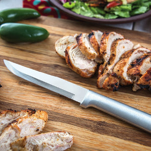 Rada Cutlery Stubby Butcher Knife with silver handle on cutting board with sliced meat.