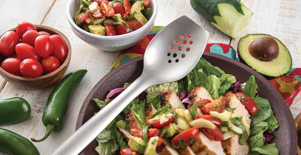 RADA stainless steel chef's spoon over a plate of chicken salad and sliced avocado