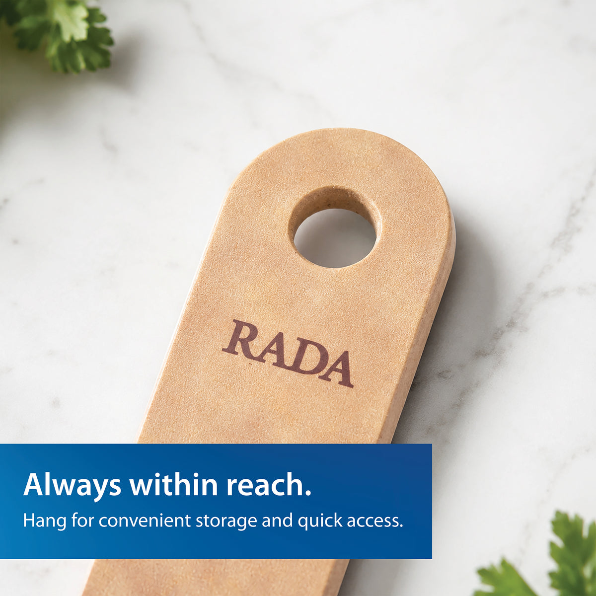 Close-up of the Everyday Slotted Turner spatula with the brand name RADA printed in dark brown on a white marble surface. Blue text banner says 'Always within reach. Hang for convenient storage and quick access.'