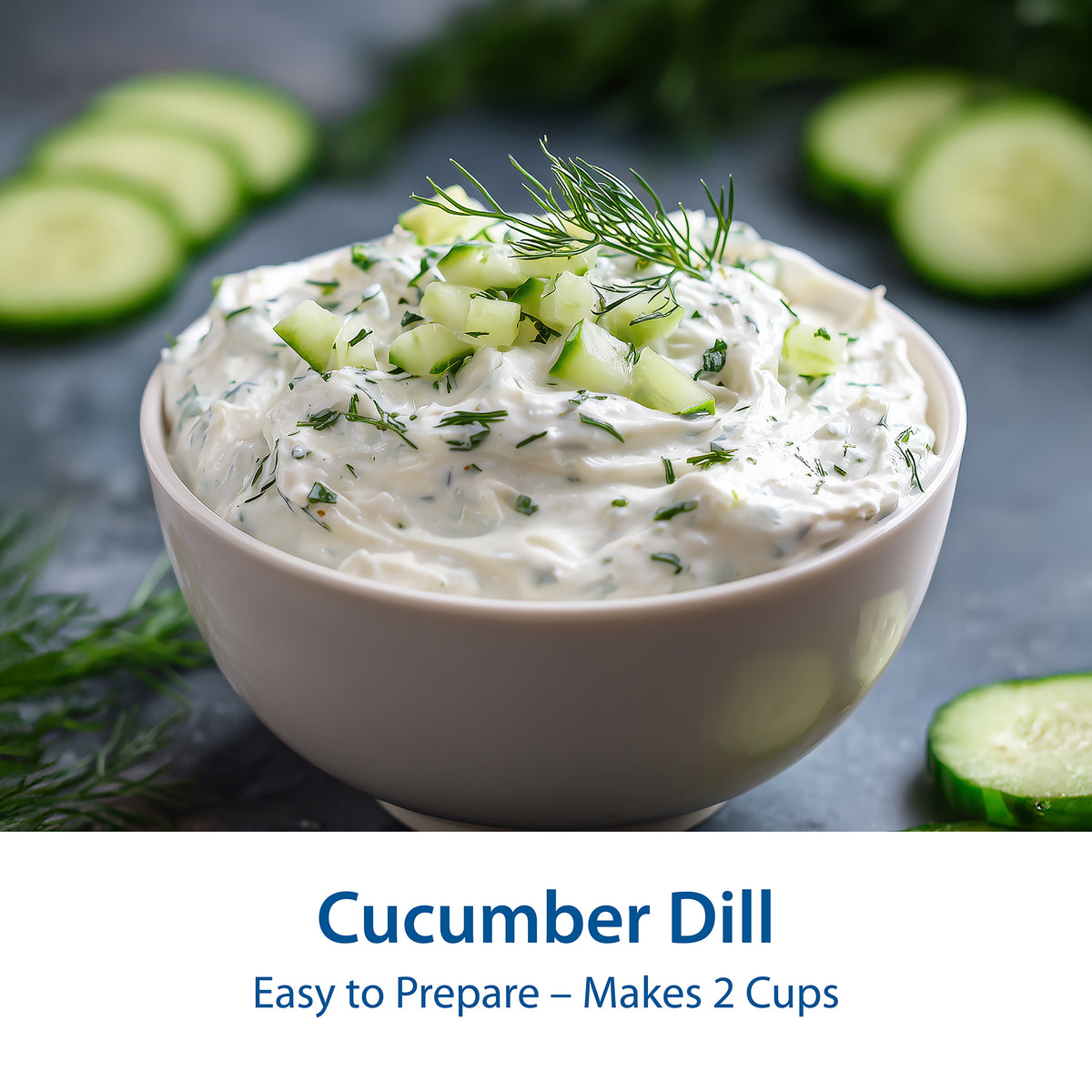 A bowl of creamy Cucumber Onion Dill dip topped with chopped cucumber and fresh dill, with sliced cucumbers and dill scattered around on a dark surface. Text at the bottom reads 'Cucumber Dill' and 'Easy to Prepare – Makes 2 Cups'.