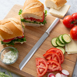 Rada 8 Inch Bread Knife with loaded sandwiches on a cutting board.