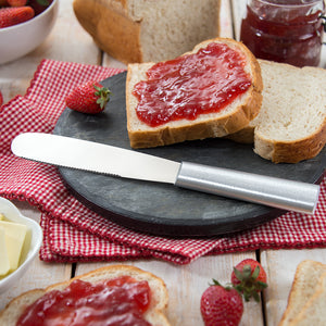Super Spreader with silver handle and bread with jelly on top.