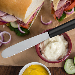 Silver handle Super Spreader with a sub sandwich on white bread.