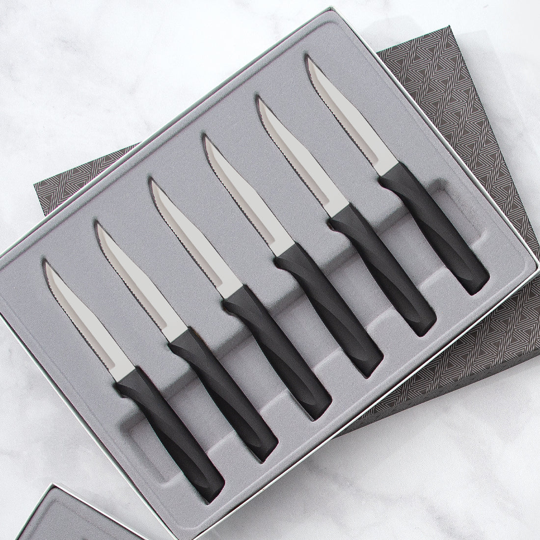 Rada Cutlery Anthem Serrated Steak Set showing knives with black handles in gift box. 