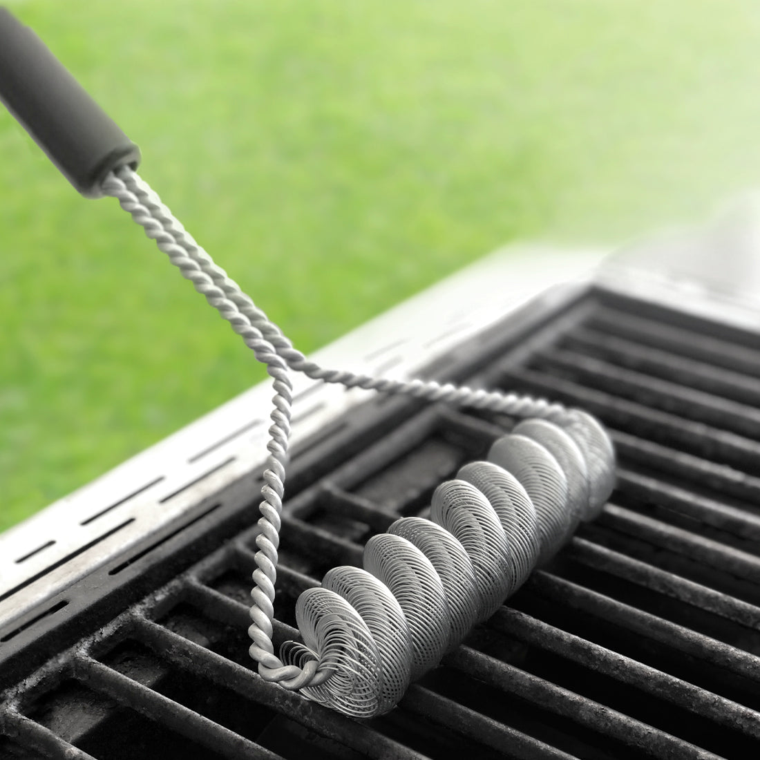 Rada Cutlery's new Grill Brush cleaning a grill grate.