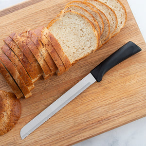 Anthem Bread Knife on a cutting board next to sliced bread.