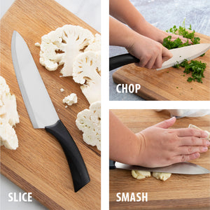 Slice. Chop. Smash. French Chef knife on board with sliced cauliflower, chopping fresh parsley and smashing garlic cloves.