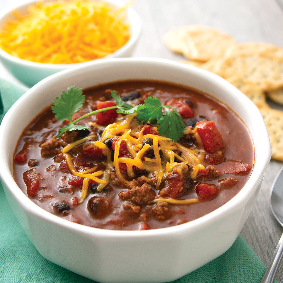 Prepared Black Bean Chili in a white bowl garnished with cheese.