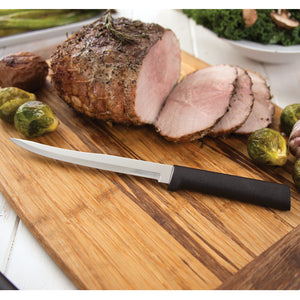 Carver/Boner Knife with black handle on cutting board with sliced ham. 