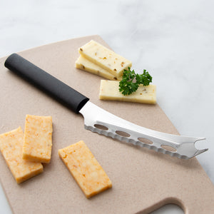 Rada Cutlery Cheese Knife with black handle on cutting board with cheese slices. 