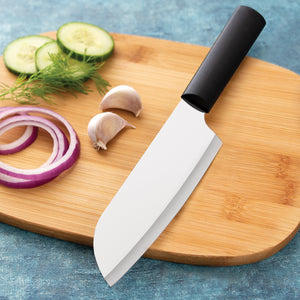 Rada Cutlery Cook's knife with black handle on wooden cutting board with sliced onion and cucumber