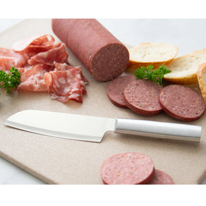Cook's Utility knife with silver handle on cutting board by sliced sausage