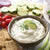 Cucumber Onion Dill Dip mixed with sour cream and served with crackers and veggies. 