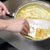 A cook using the Rada Daisy PanMate Scraper to scrape off baked-on scrambled eggs out of a frying pan. 