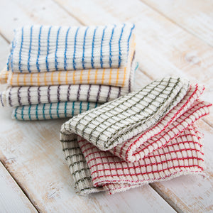 Stack of woven multi-colored dishcloths. 