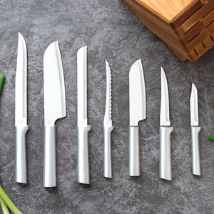 Seven silver aluminum-handled knives beside Essential Oak Block