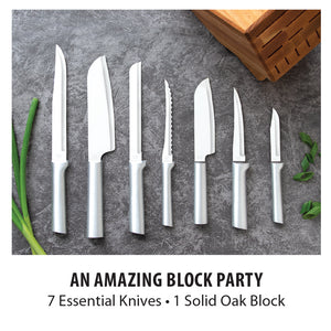 An Amazing Block Party. 7 Essential Knives, 1 Solid Oak Block. Photo shows 7 silver handled knives on gray countertop.