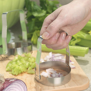 Food Chopper dicing red onion on wooden cutting board with celery in background
