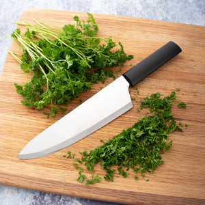 Rada Cutlery French Chef Knife with black handle and minced herbs