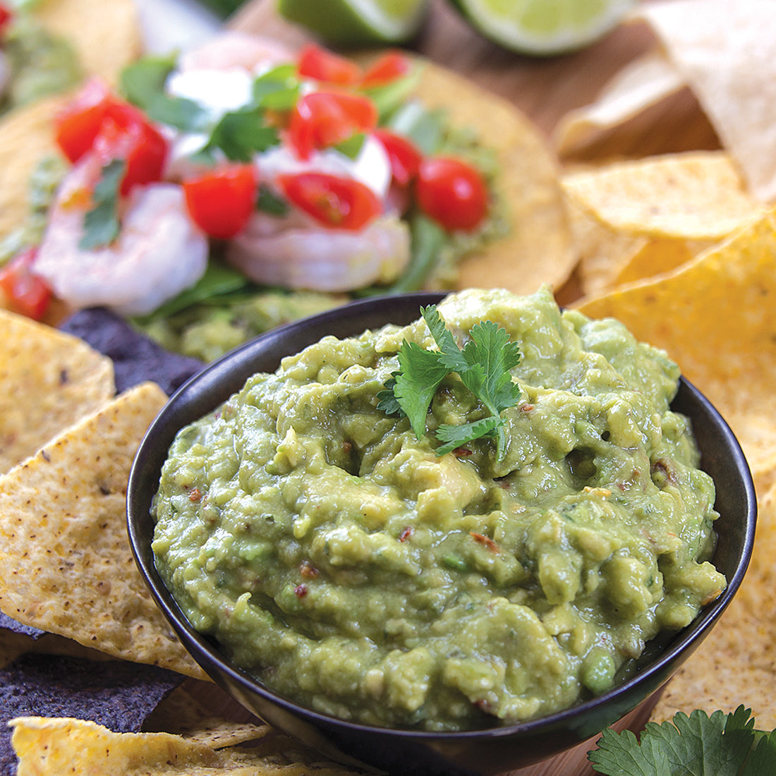A bowl of prepared guacamole (made with Guacamole Quick Mix, avocados & water) and tortilla chips 