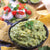 A bowl of prepared guacamole (made with Guacamole Quick Mix, avocados & water) and tortilla chips 