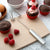 Rada Cutlery Handi-Stir with silver handle beside chocolate cupcakes and raspberries