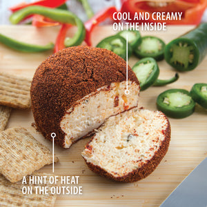 A Rada Sweet Hot Pepper Cheeseball on a cutting board. Cool and creamy on the inside. A hint of heat on the outside. 