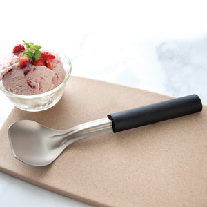Rada Cutlery Ice Cream Scoop with black handle and stainless steel bowl beside strawberry ice cream 