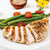 Italian Herb & Garlic Marinade shown on grilled chicken served with asparagus and cherry tomatoes