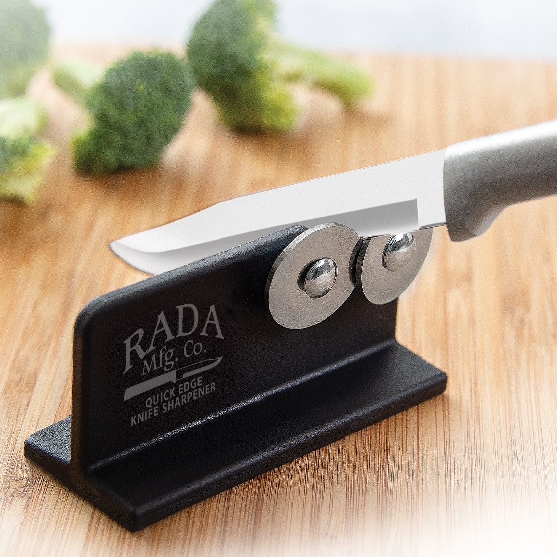Rada Cutlery black Quick Edge Knife Sharpener with steel wheels sharpening a paring knife