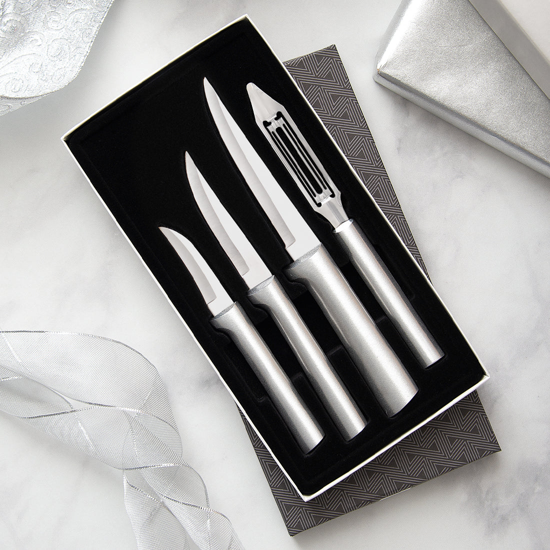 Meal Prep Gift Set with silver handles with three knives and vegetable peeler in gift box. 