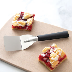 Rada Cutlery Mini Server with black handle on cutting board with cherry bars. 